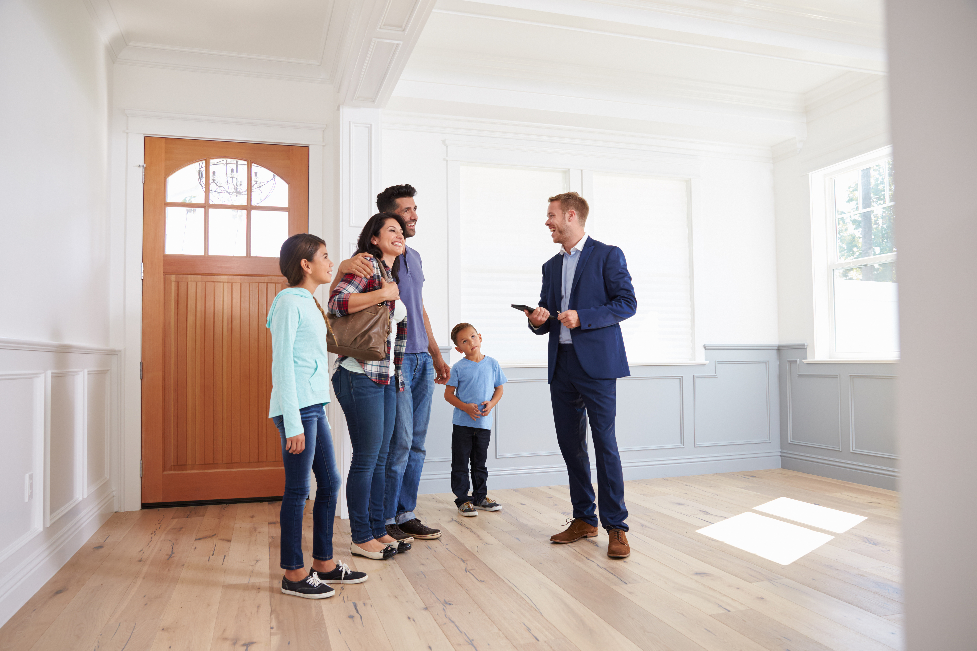 A Realtor Showing a Family a New Home