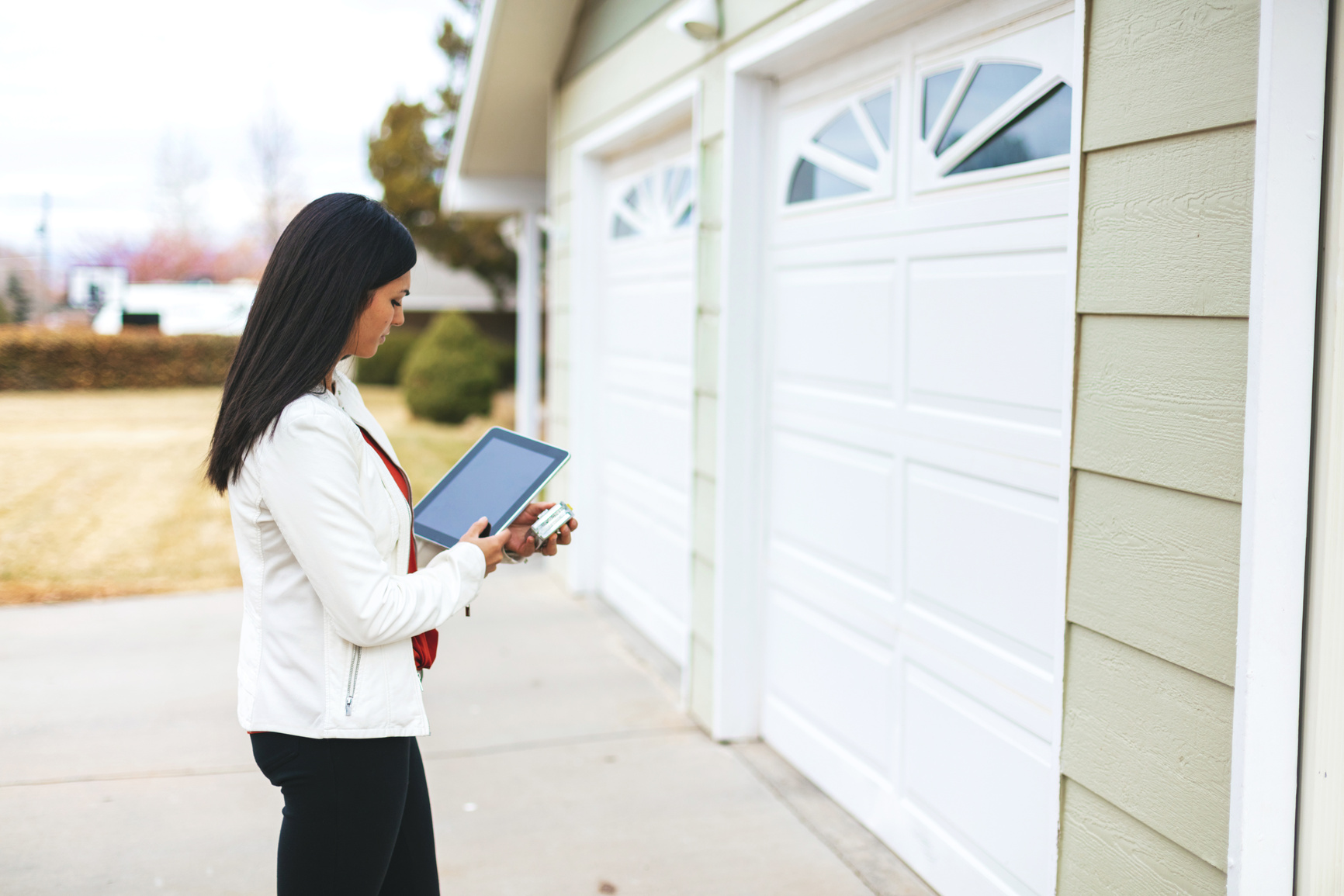 Young Adult Millennial Female Appraiser Measuring Home Features and Assessing Value in Western Colorado
